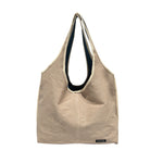 Jean-ius Reversible Tote Bag in beige, showcasing sustainable and handmade upcycled tote bag design.