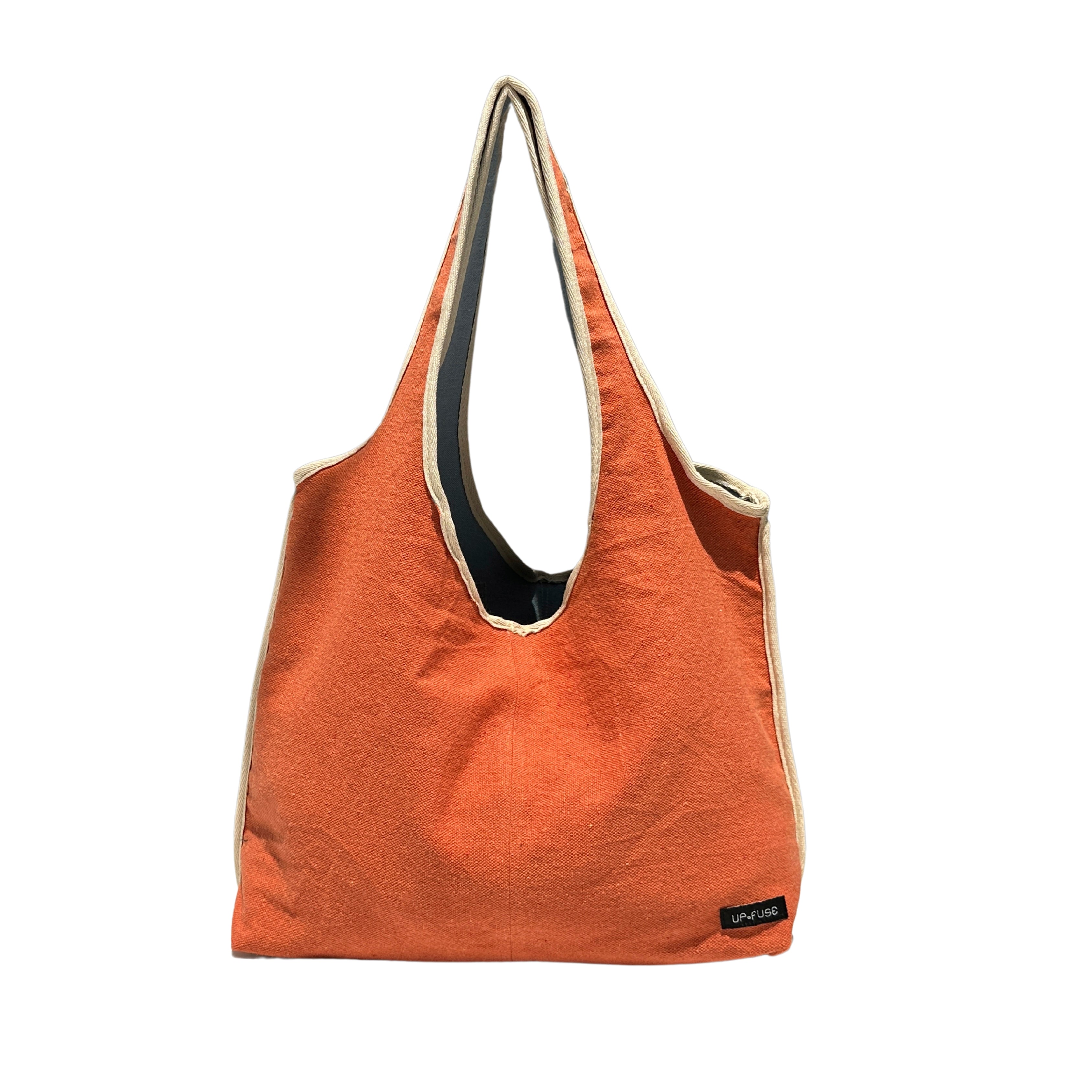 Reversible upcycled tote bag in vibrant orange, showcasing eco-friendly fashion and handmade design.